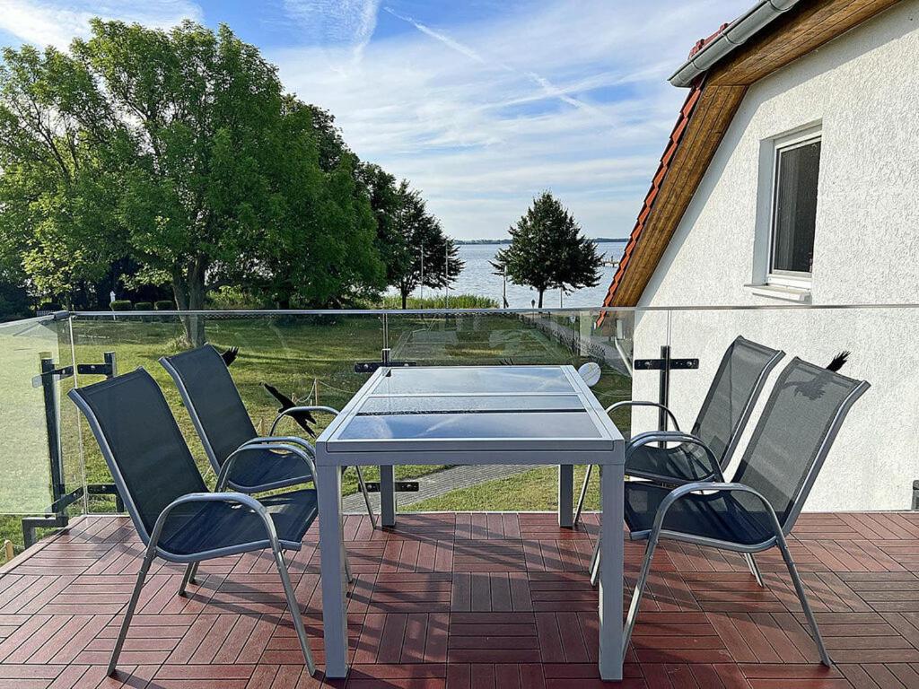 a table and four chairs on a patio at Lütt Matten Comfortable holiday residence in Dranske