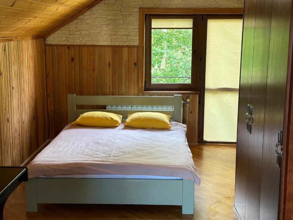 a bedroom with a bed with two pillows on it at Cottage Zelman in Yaremche