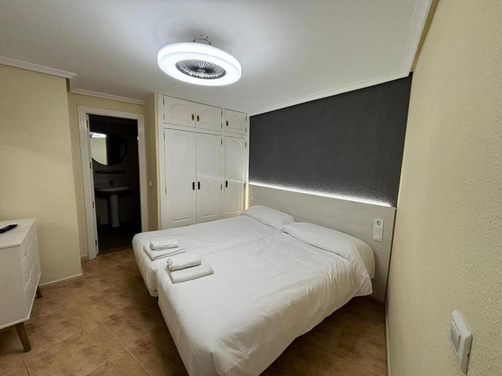 ベニドルムにあるApartamentos Carmelaのベッドルーム(大きな白いベッド1台付)