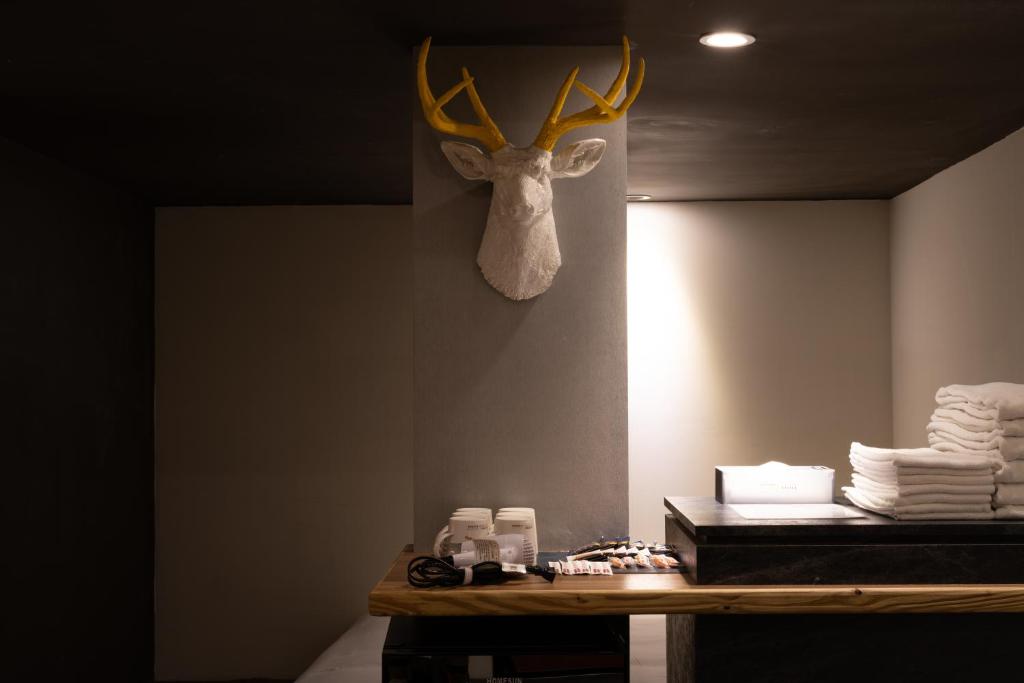 a head of a deer with antlers hanging on a wall at 凝萃文旅 台中車站店 NCH-Business Hotel in Taichung