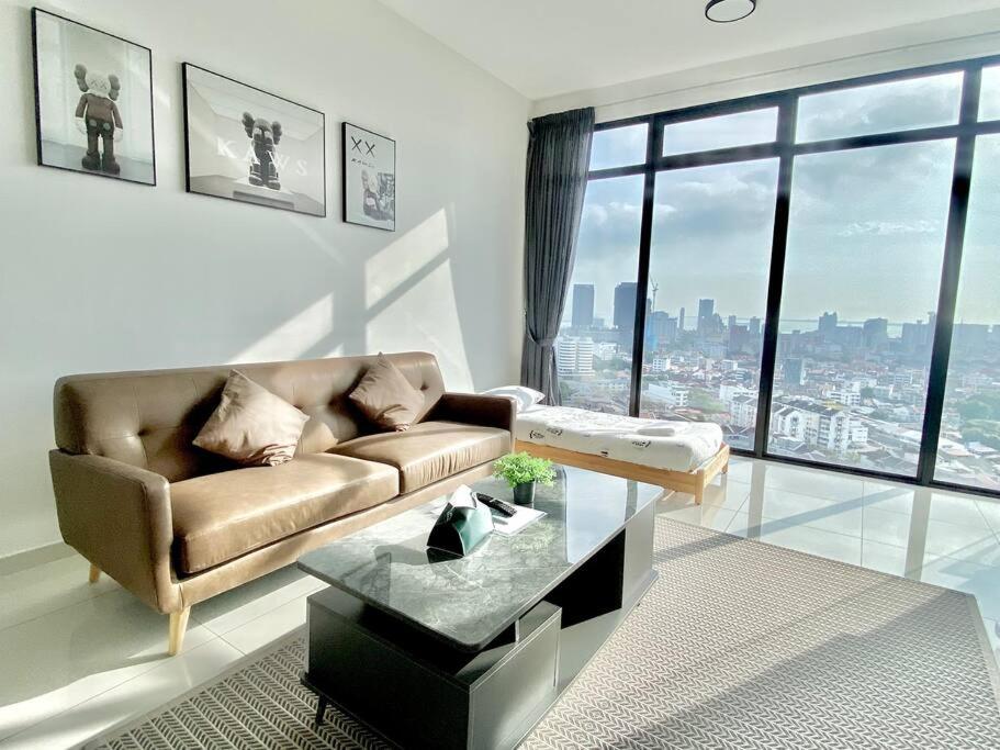 uma sala de estar com um sofá e uma grande janela em Beacon Executive Suites - KomtarView Executive Suite em George Town