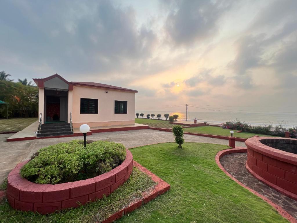 a small house with a view of the ocean at Anant Beach Villa in Ratnagiri