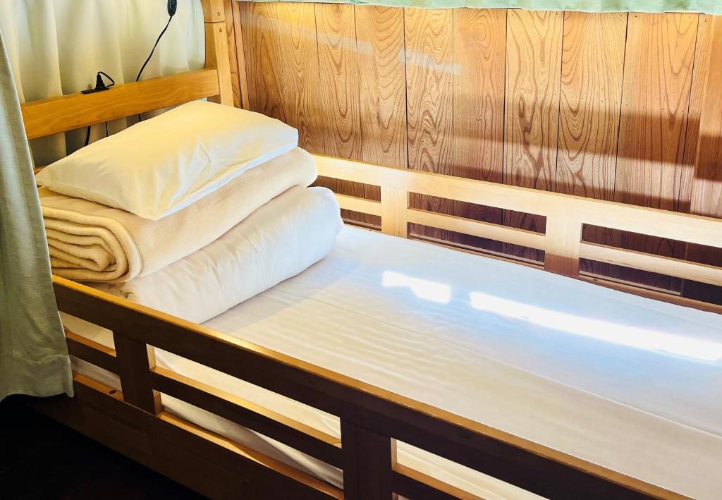 a couple of beds in a room with at Minsyuku Koshiyama in Shirakawa