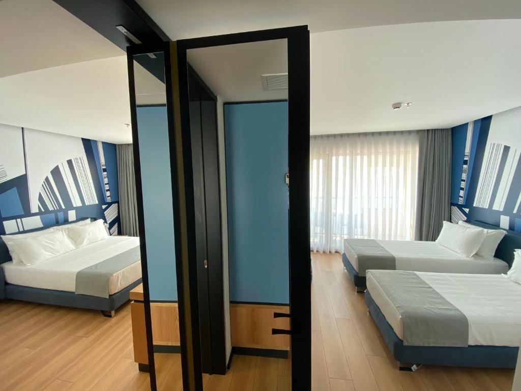 Postel nebo postele na pokoji v ubytování Amara Hotel & SPA