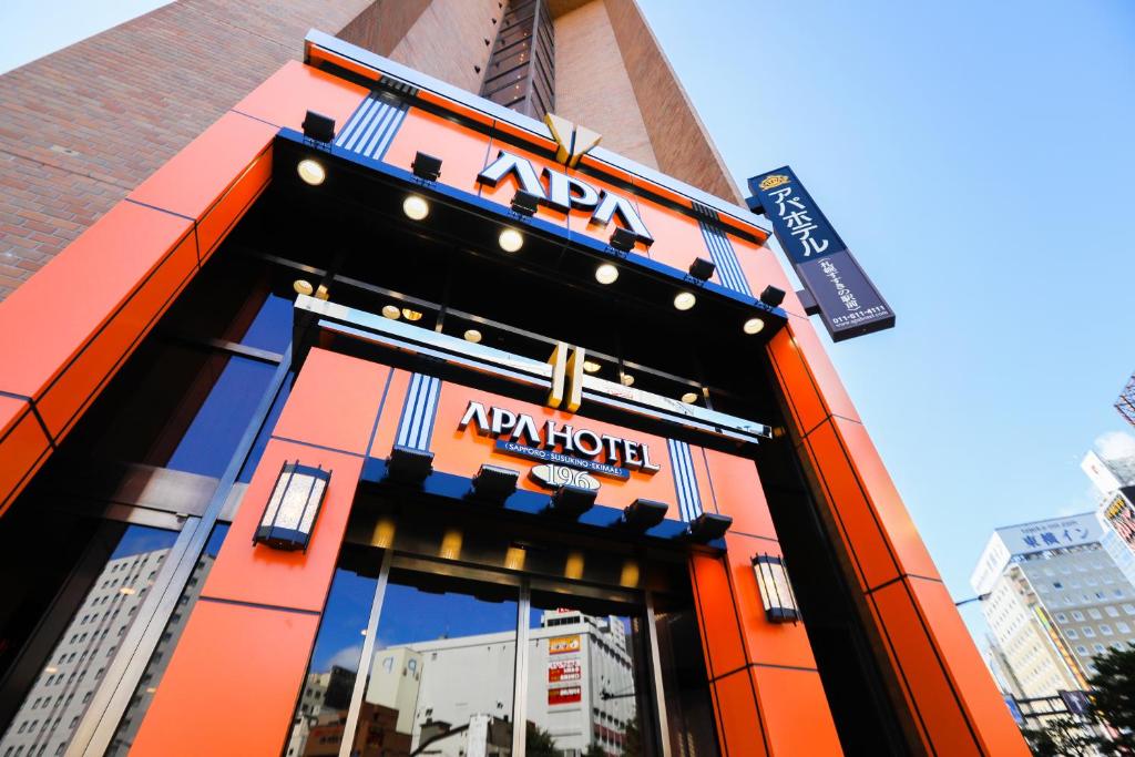 an orange building with a akoya sign on it at APA Hotel Sapporo Susukino Ekimae in Sapporo