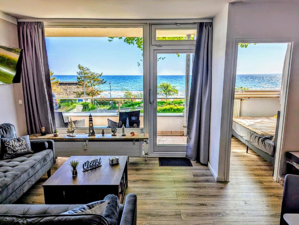 a living room with a view of the ocean at Panorama-Meerblick am Scharbeutzer Strand in Scharbeutz