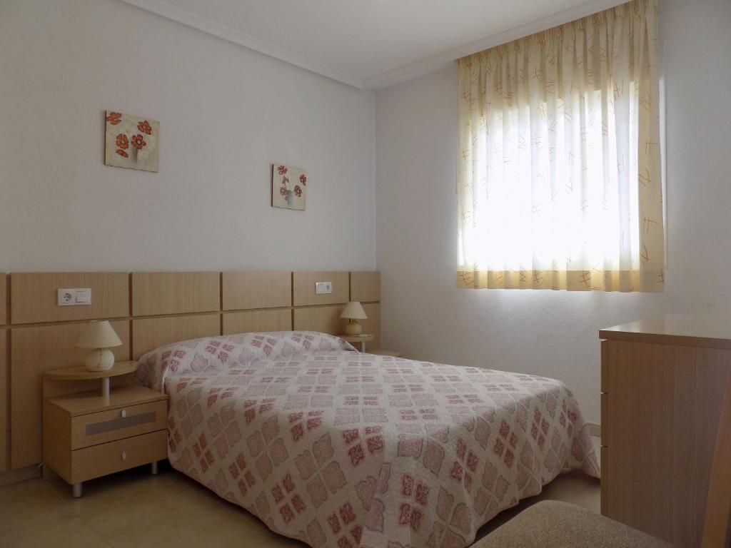 a bedroom with a bed and a window at Playa Ribera MED002 in La Estación