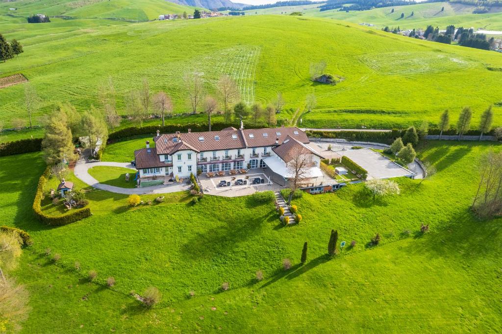 an aerial view of a large house in a field at Villa Bonomo Charme Hotel in Asiago