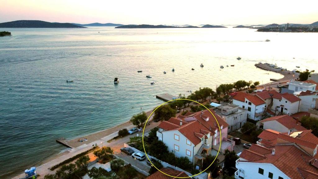 an aerial view of a beach with people in the water at Villa Aurelia Vodice in Vodice