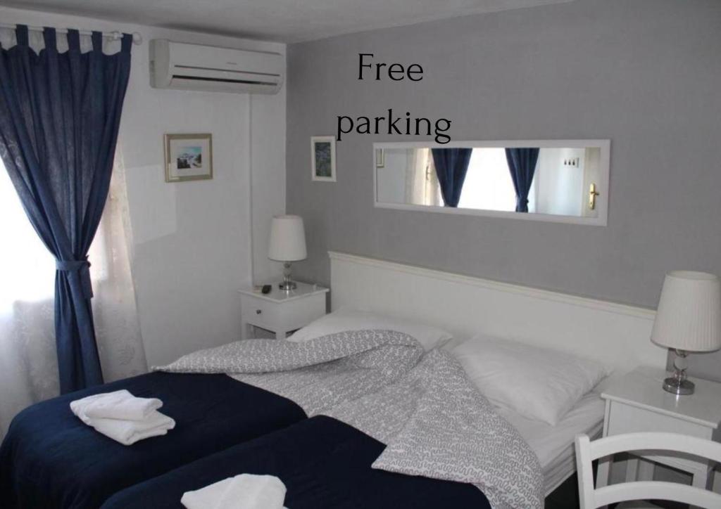 a bedroom with a bed with a free parking sign at Karmelita's place -studio in Šibenik