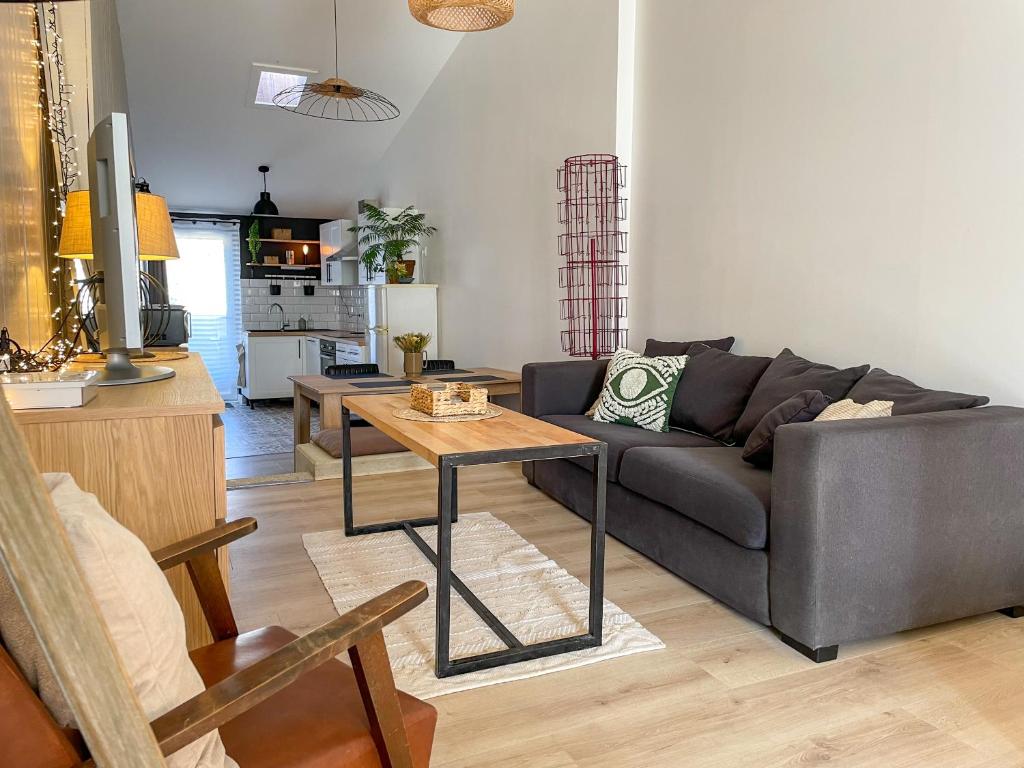 un salon avec un canapé et une table dans l'établissement Maison cosy et atypique, à Arzens