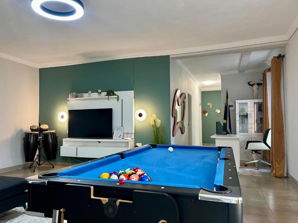 a living room with a pool table and a tv at 435 on vale boutique aparthotel in Johannesburg