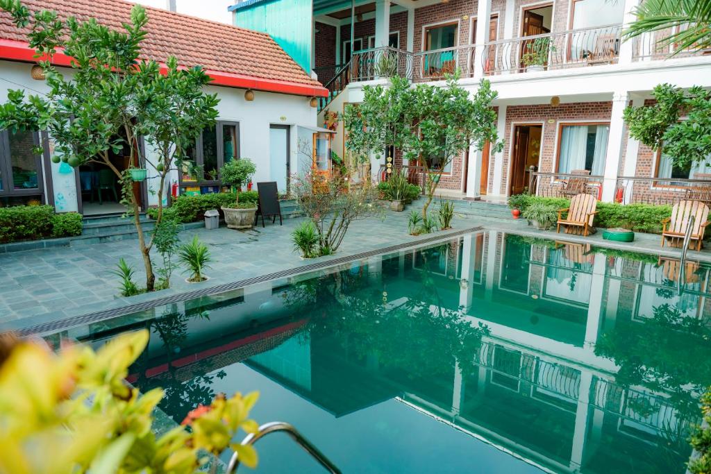 a swimming pool in front of a building at Mai Mountain Homestay in Ninh Binh
