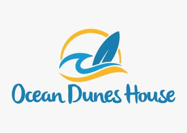 a logo for a ocean dances house with a dolphin at Ocean Dunes House in Tamellalt