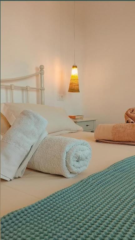 a bedroom with a bed with a towel on it at Traditional suites in Chora Kythnos #7 in Kithnos