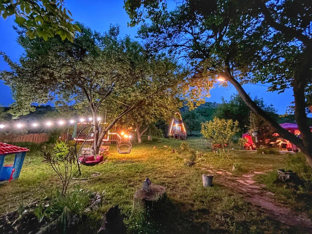 a garden at night with a tent in the background at Teo's Cottages in Dedoplis Tskaro