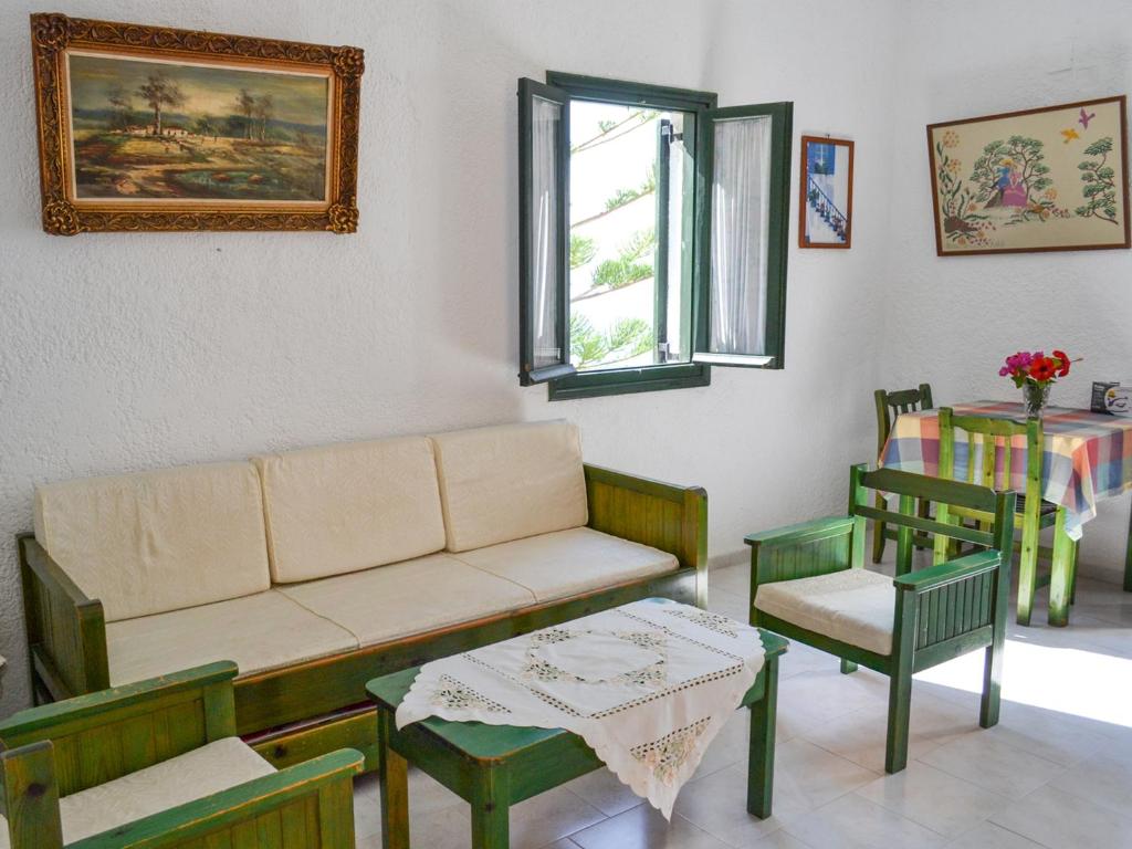 a living room with a couch and chairs and a table at Hotel Finiki View in Foiníkion
