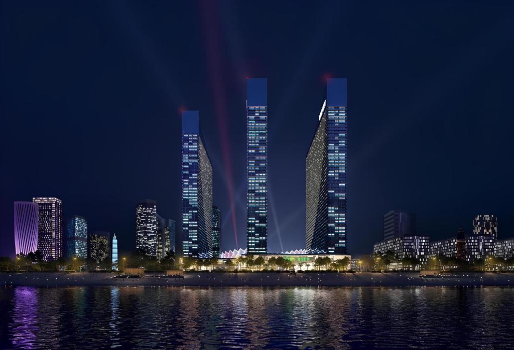grupa wysokich budynków w mieście w nocy w obiekcie Orbi city Panorama towers w mieście Batumi