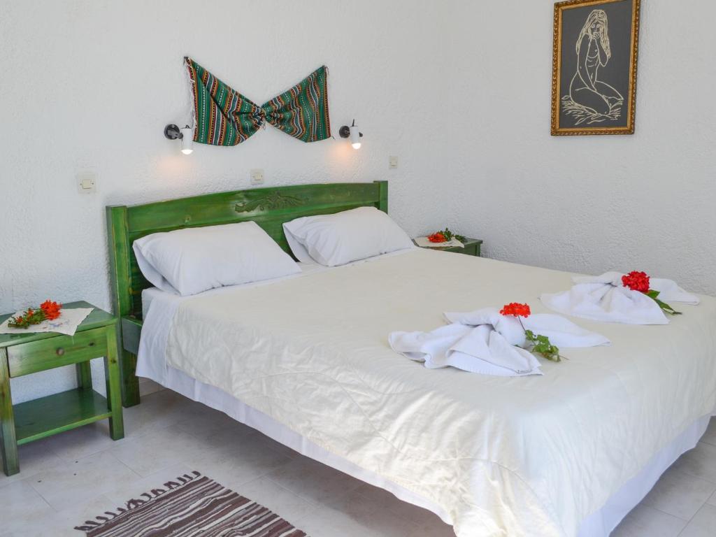 a bedroom with a bed with towels on it at Hotel Finiki View in Foiníkion