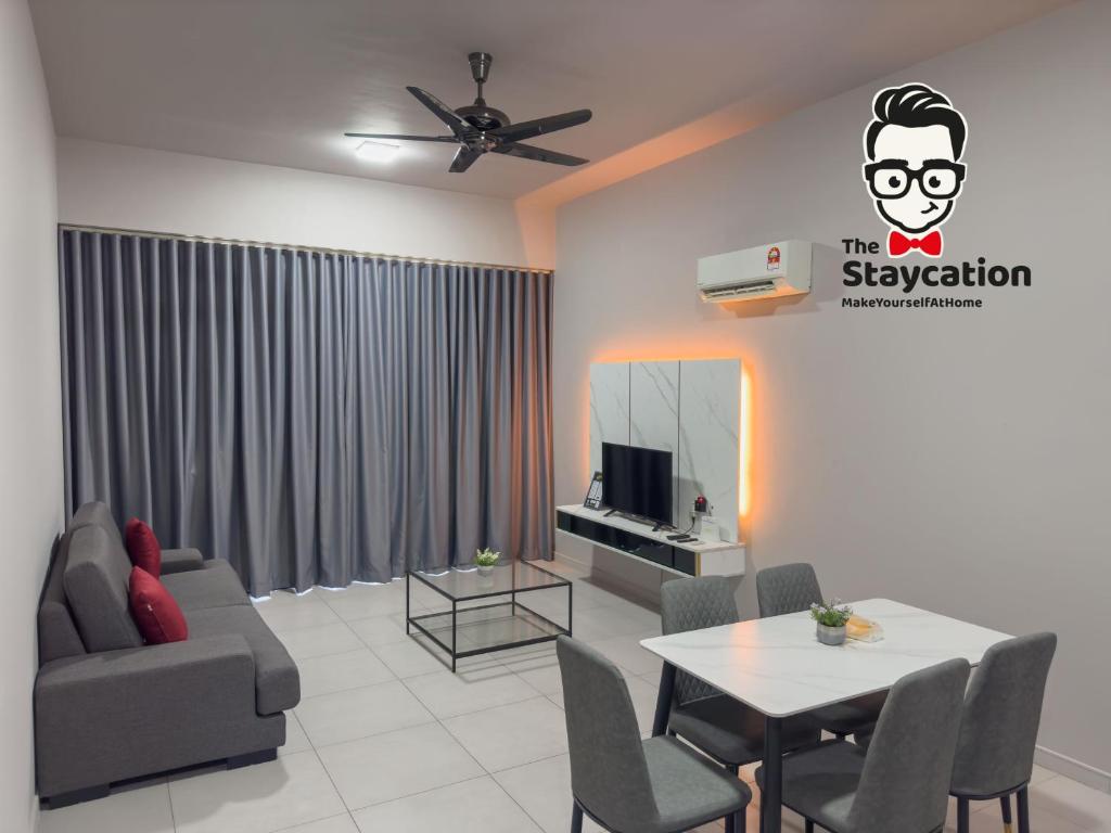 a living room with a couch and a table at Staycation Homestay 32 The Echelon near Saradise in Kuching