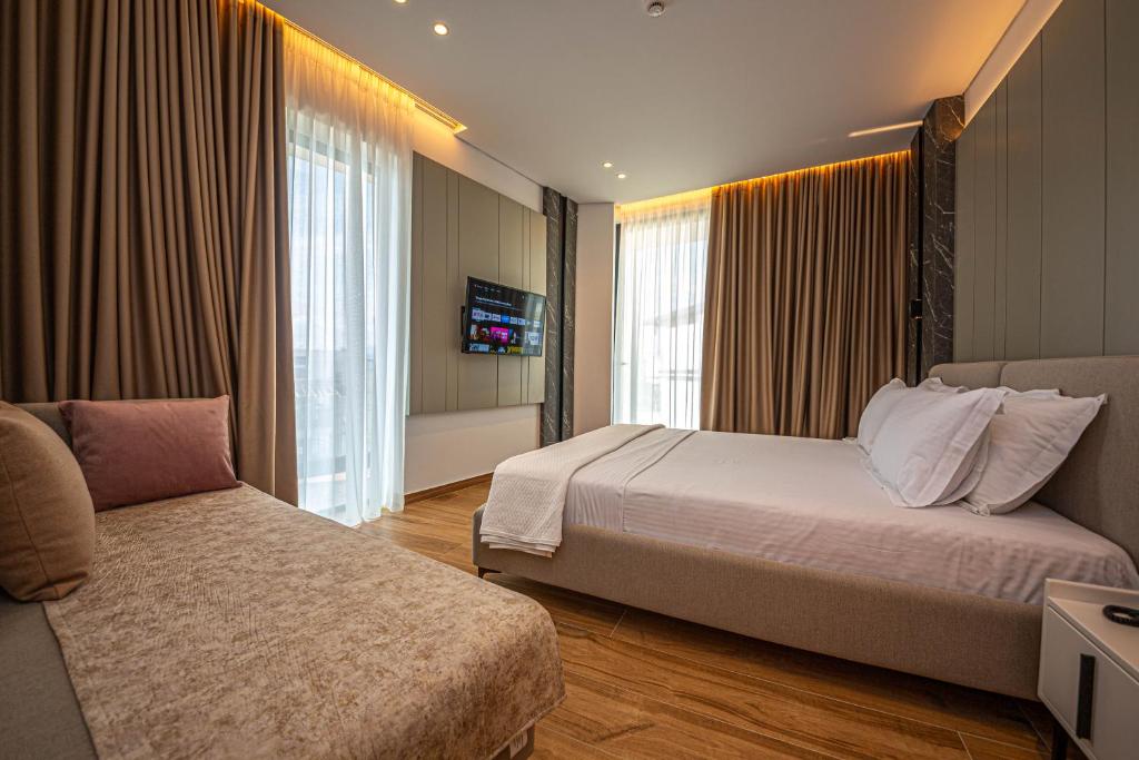 Voodi või voodid majutusasutuse Nobbu Hotel Ksamil toas