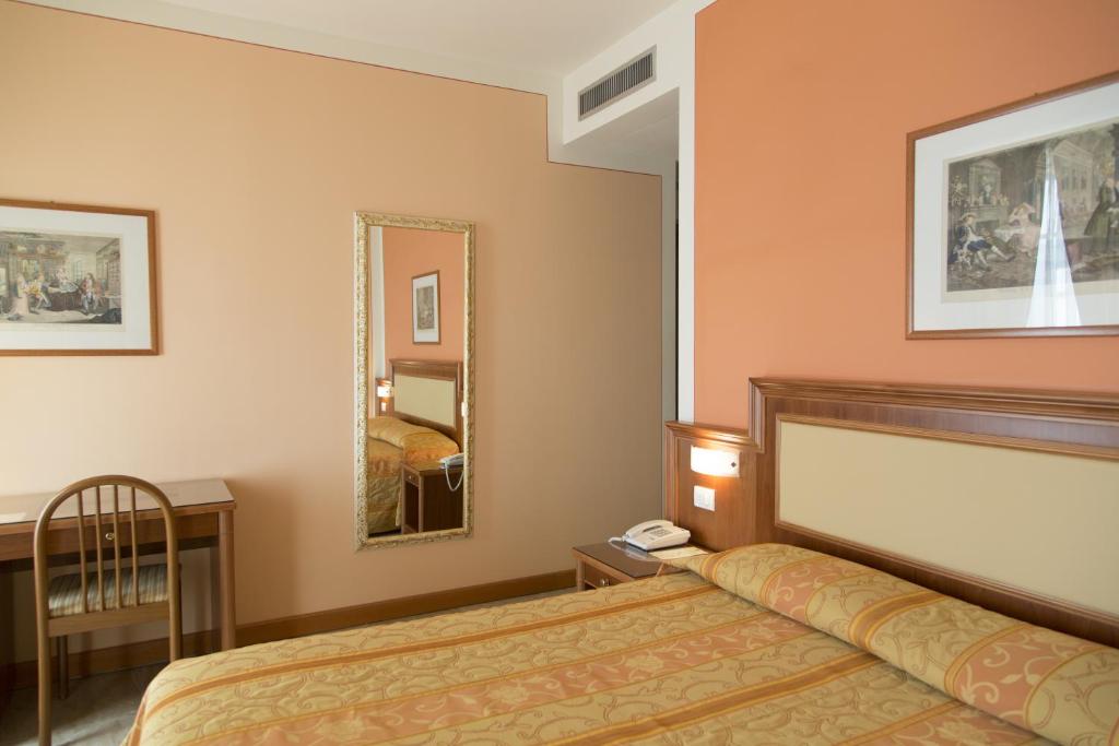 Postel nebo postele na pokoji v ubytování Hotel Belvedere San Gottardo by LVG Hotel Collection