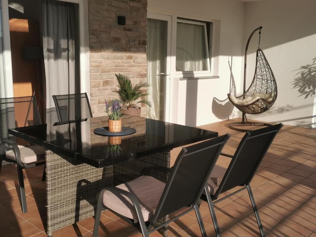 a dining room with a black table and chairs at Apartman Klara in Karlobag