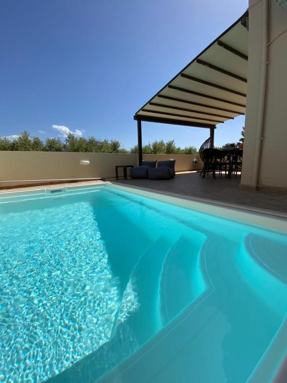a swimming pool in a house with a pergola at Villa KIMA Heated Pool in Episkopi (Heraklion)