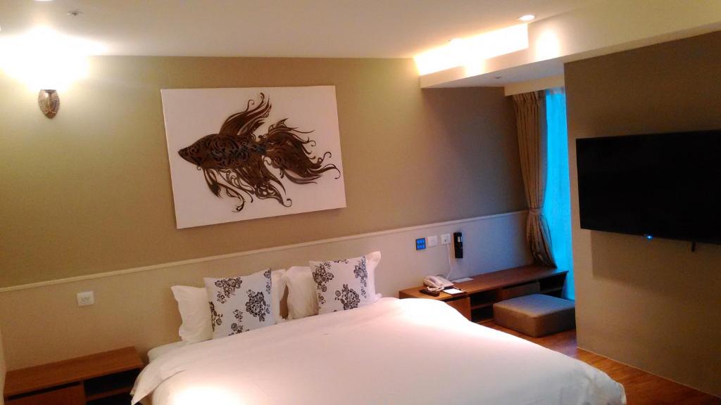 Postel nebo postele na pokoji v ubytování Walker Hotel. Ximen