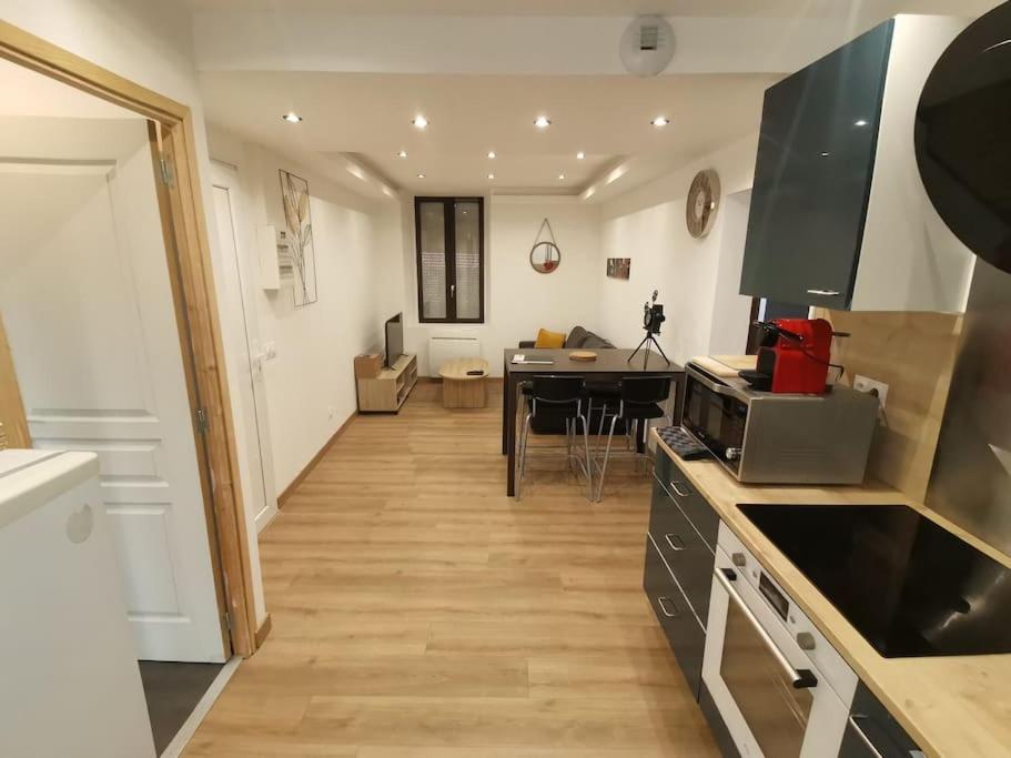 une cuisine avec une table et une salle à manger dans l'établissement lahoré djadja, à Reims