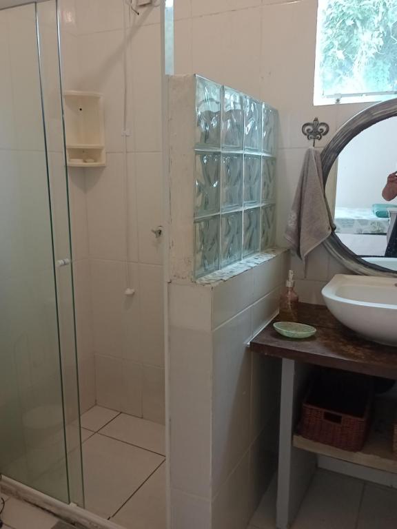 a bathroom with a glass shower and a sink at Solar Lisboa 100 m da Praia com vista para mar in Balneário Camboriú