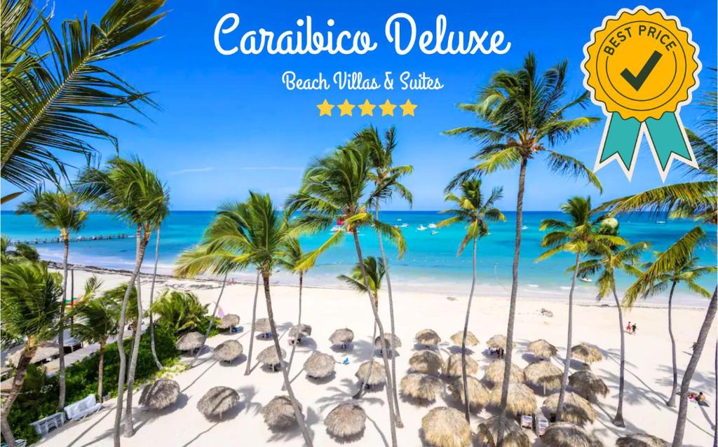 a view of a beach with palm trees and the ocean at CARAIBICO DELUXE Beach Club & SPA in Punta Cana