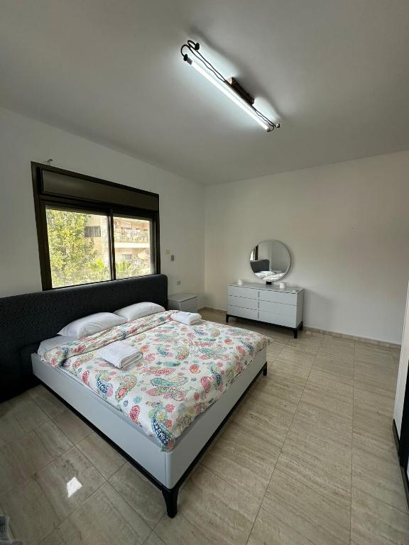 a bedroom with a large bed and a window at New Apartment in Nablus City in Mashabbe Sade