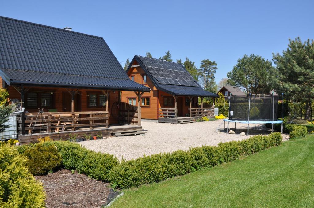 une maison avec des panneaux solaires sur le toit dans l'établissement Sosenka Domki, à Odargowo