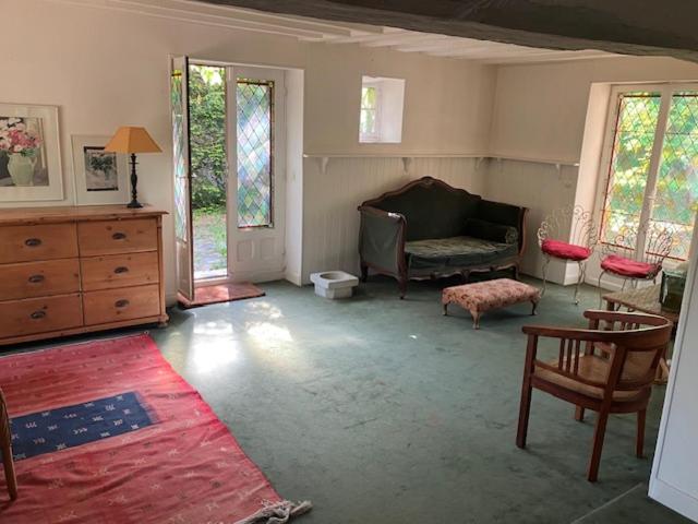 a living room with a couch and a table at cottage à bethemont la foret in Béthemont-la-Forêt