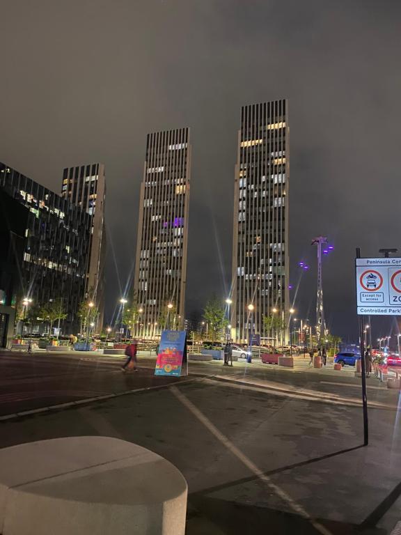 a group of tall buildings in a city at night at Luxury stay near O2 and canary wharf in London