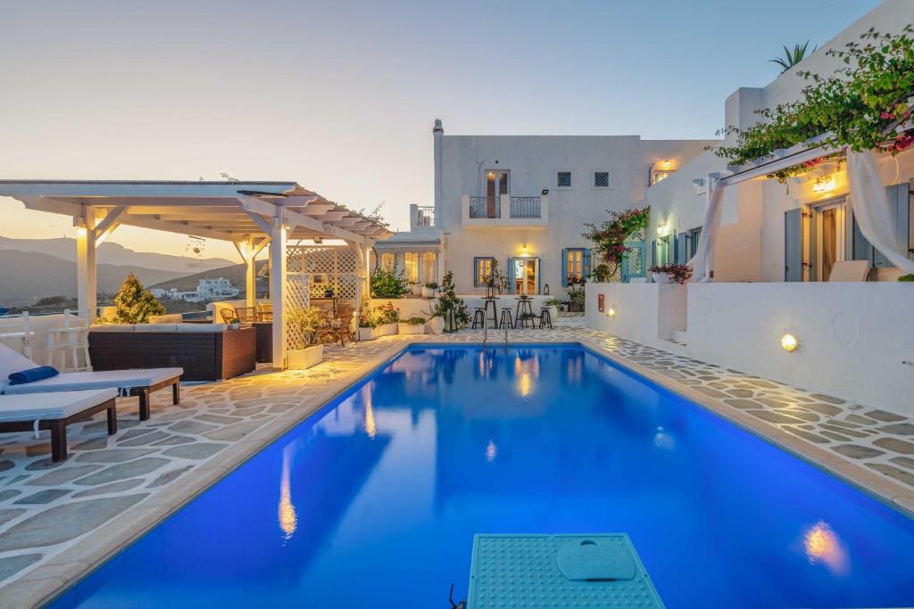 a villa with a swimming pool and a house at Studios Kilindra in Astypalaia