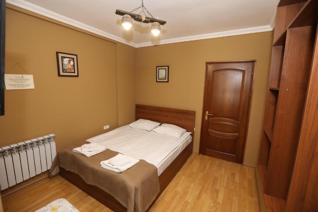 Popock Baghramyan في يريفان: غرفة نوم صغيرة بسرير وباب خشبي