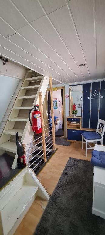 a living room with a staircase in a house at Monteurzimmer Lollar in Lollar