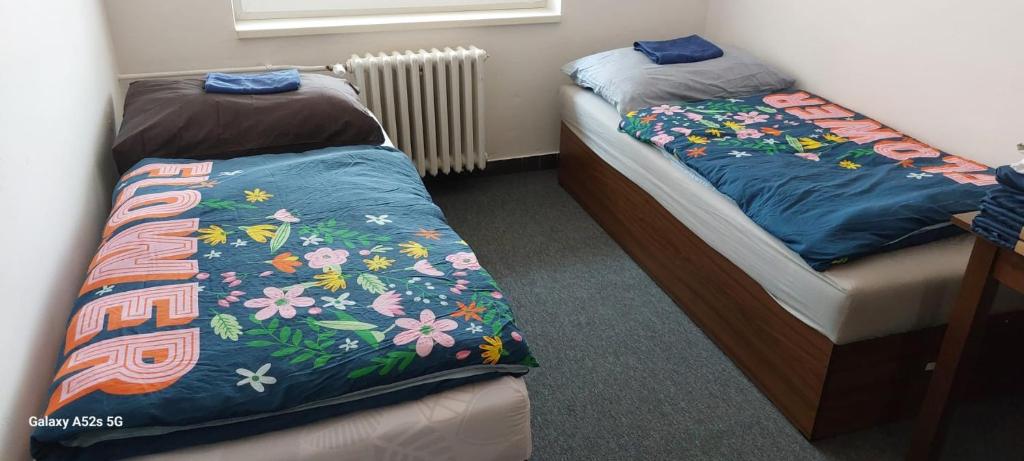 two twin beds in a room with at TJ Baník Ostrava in Ostrava