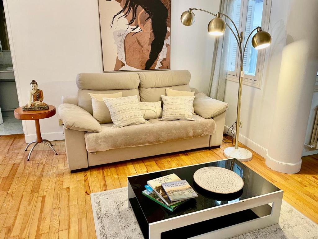 a living room with a couch and a table at Con Encanto in San Sebastián