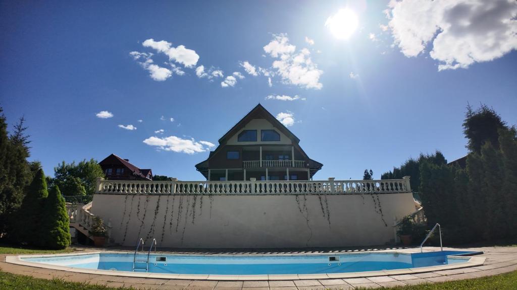 a house on top of a wall with a swimming pool at Zawóz 20 in Zawóz