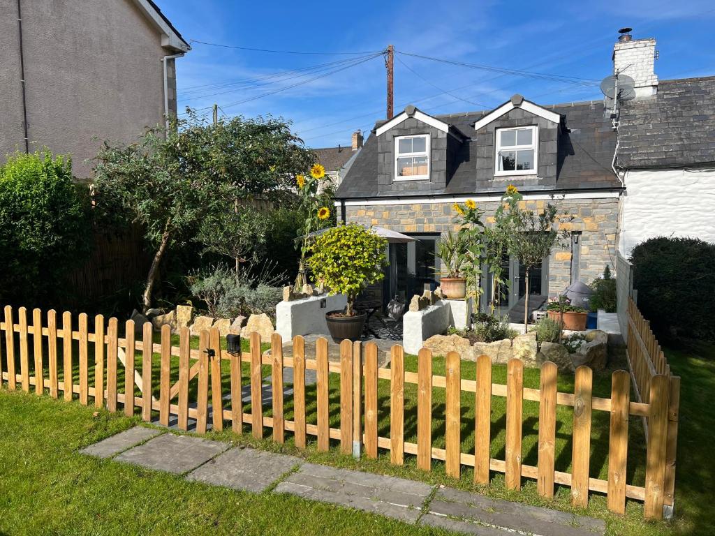 a wooden fence in front of a house at The End House at The Old Farmhouse in Cowbridge