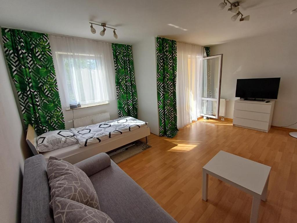 a living room with a couch and a tv at Schöne Ferienwohnung. Nähe Playmobil und Messe Nbg in Fürth