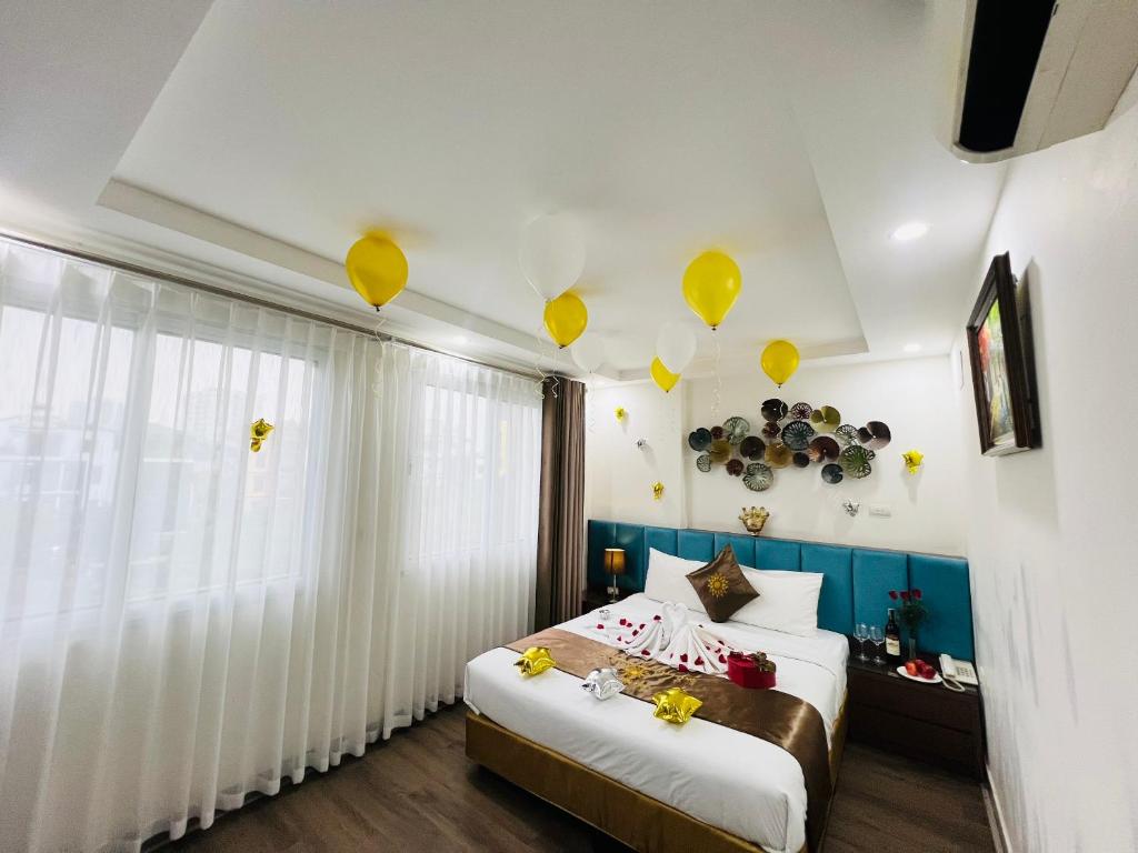 a bedroom with a bed with yellow balloons on the ceiling at Khách Sạn 239 in Hanoi