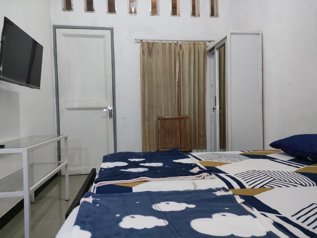 Postel nebo postele na pokoji v ubytování Hotel Residence 5 Syariah