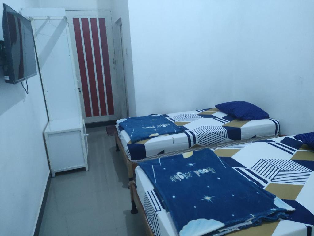 Postel nebo postele na pokoji v ubytování Hotel Residence 5 Syariah