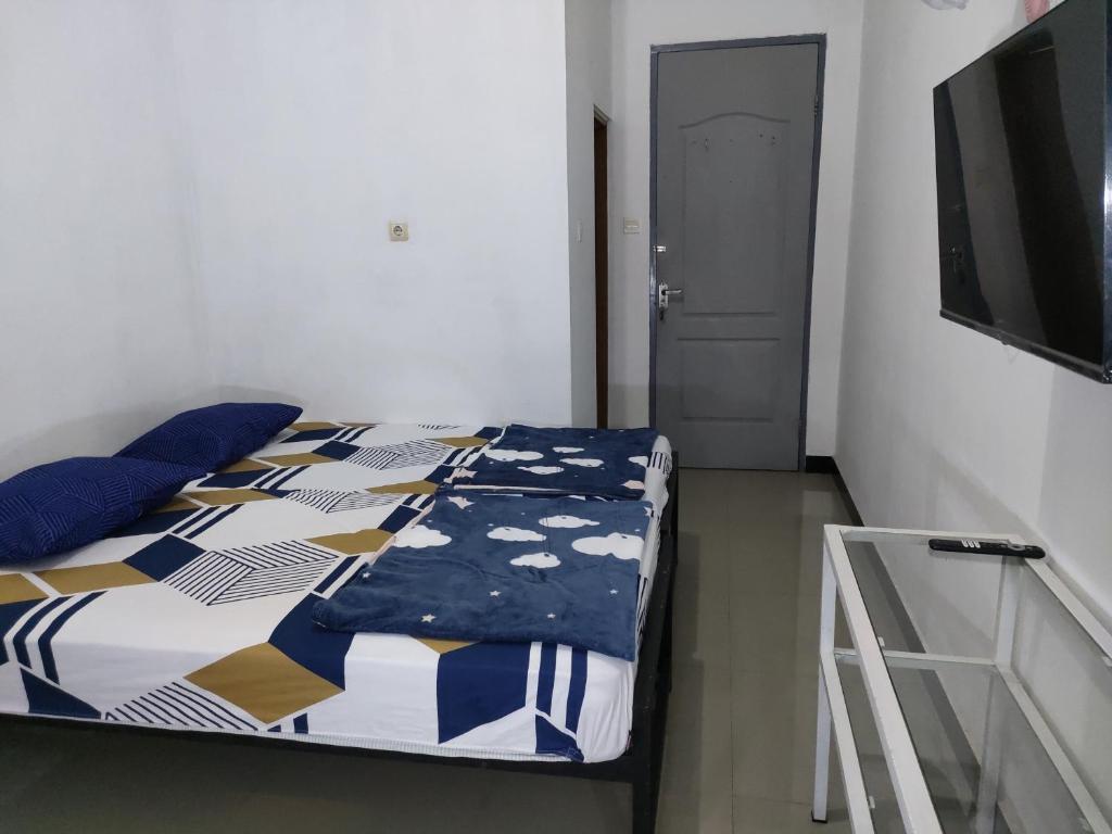 Postel nebo postele na pokoji v ubytování Hotel Residence 5 Syariah