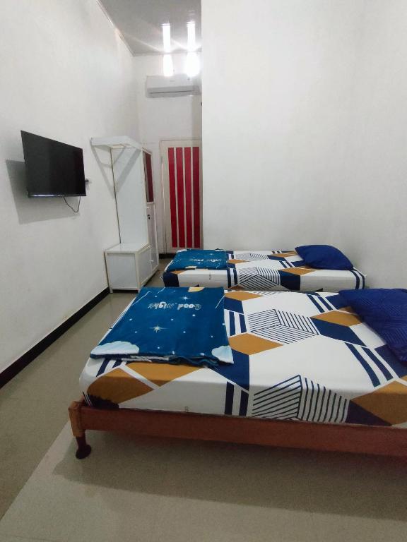 Postel nebo postele na pokoji v ubytování Hotel Residence 5 Syariah