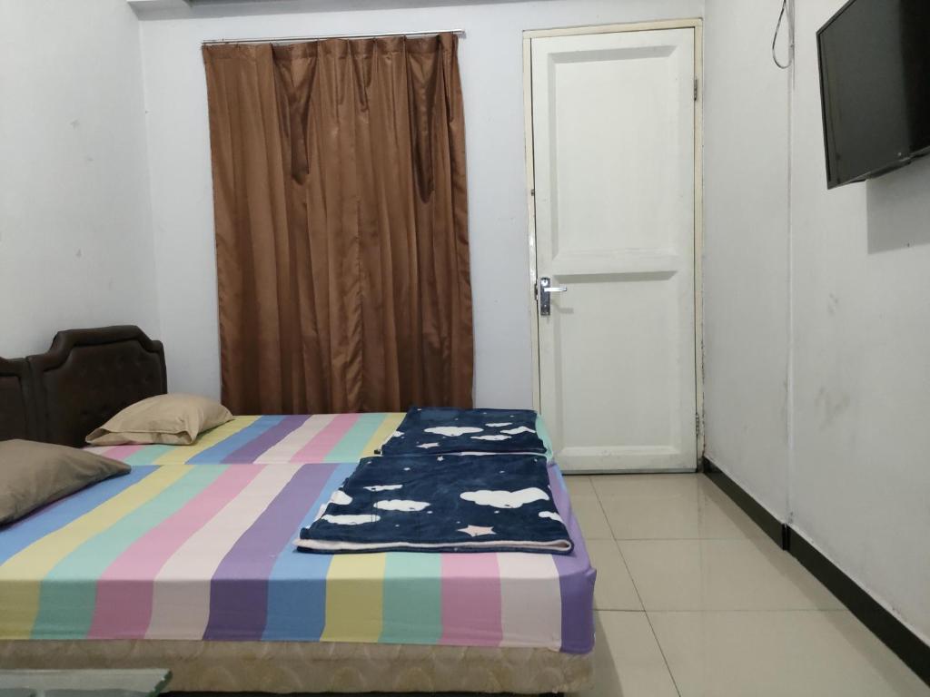 Postel nebo postele na pokoji v ubytování Hotel Residence 5 Syariah